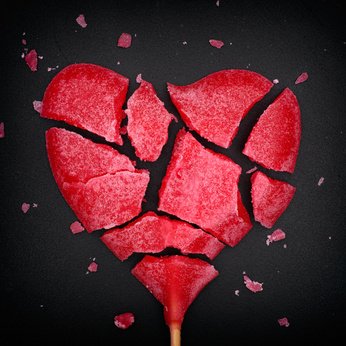 Broken red heart shaped lollipop
