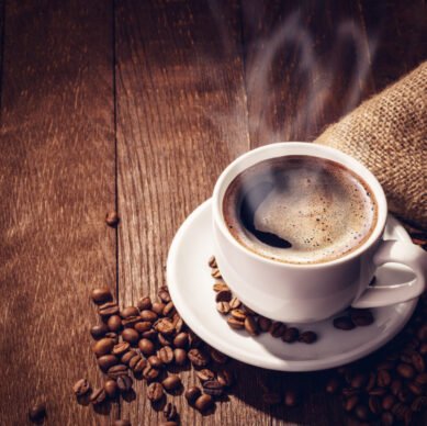 Cup coffee beans wooden dark background