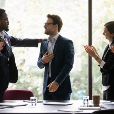 Grateful diverse team expressing recognition, appreciation, acknowledge to leader, clapping hands, touching shoulder, congratulating boss on achieve, good work result, applauding promoted coworker