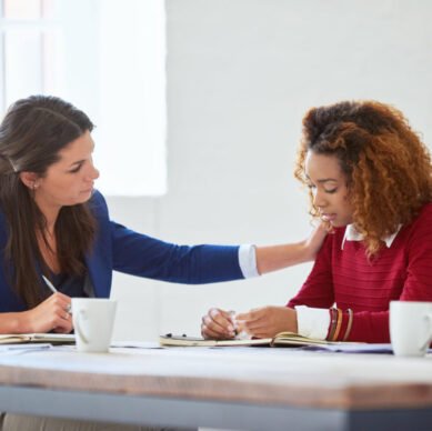 Business people, staff and women with comfort, empathy and care with professional, career and meeting. Coworkers, friends and manager with an employee, sympathy and grief with loss, sad and emotional.