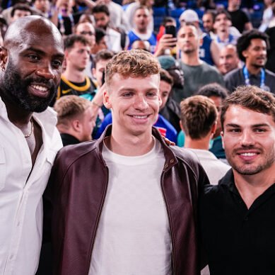 PARIS, FRANCE - AUGUST 10: Teddy Riner of France, Leon Marchand of France and Antoine Dupont of France attend the Men's Gold Medal Game, Game 50, match between France and United States on day fifteen of the Olympic Games Paris 2024 at Bercy Arena on August 10, 2024 in Paris, France. (Photo by Jari Pestelacci/Eurasia Sport Images/Getty Images)