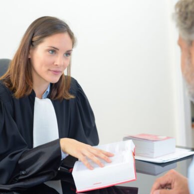 female lawyer holding book in meeting with male client